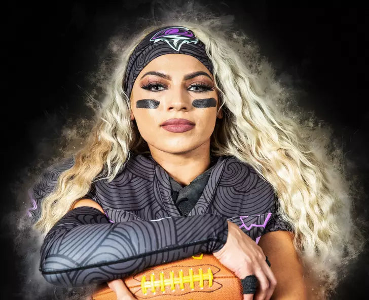 A person wearing a patterned sports uniform and holding a football